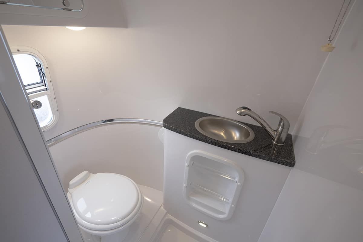 Small dark FiberGranite vanity top with a stainless sink
