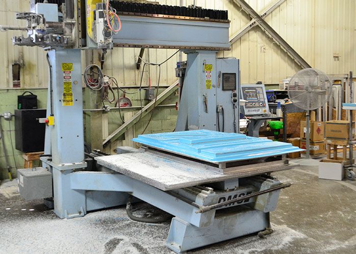 CNC router cutting a blue tooling pattern