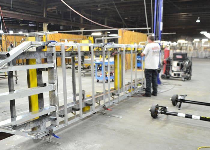 Aluminum trailer frames lined up on the assembly floor