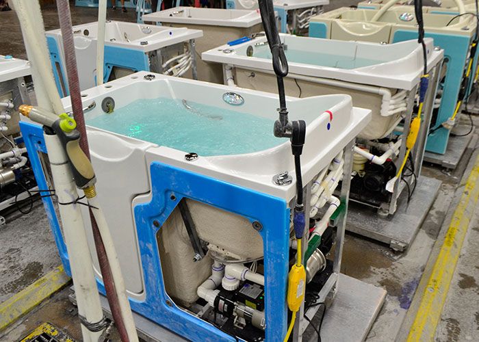 Walk-in tubs filled with water on the production line