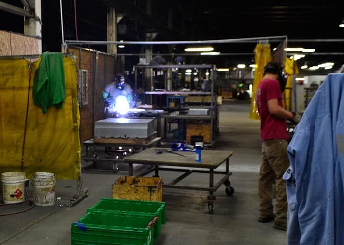 Welding arc lighting up a fabrication bay