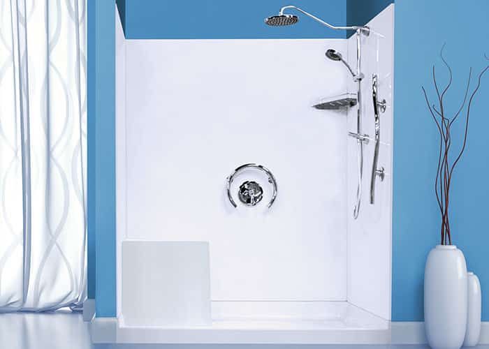 White one-piece fiberglass shower with a rain head and handheld sprayer